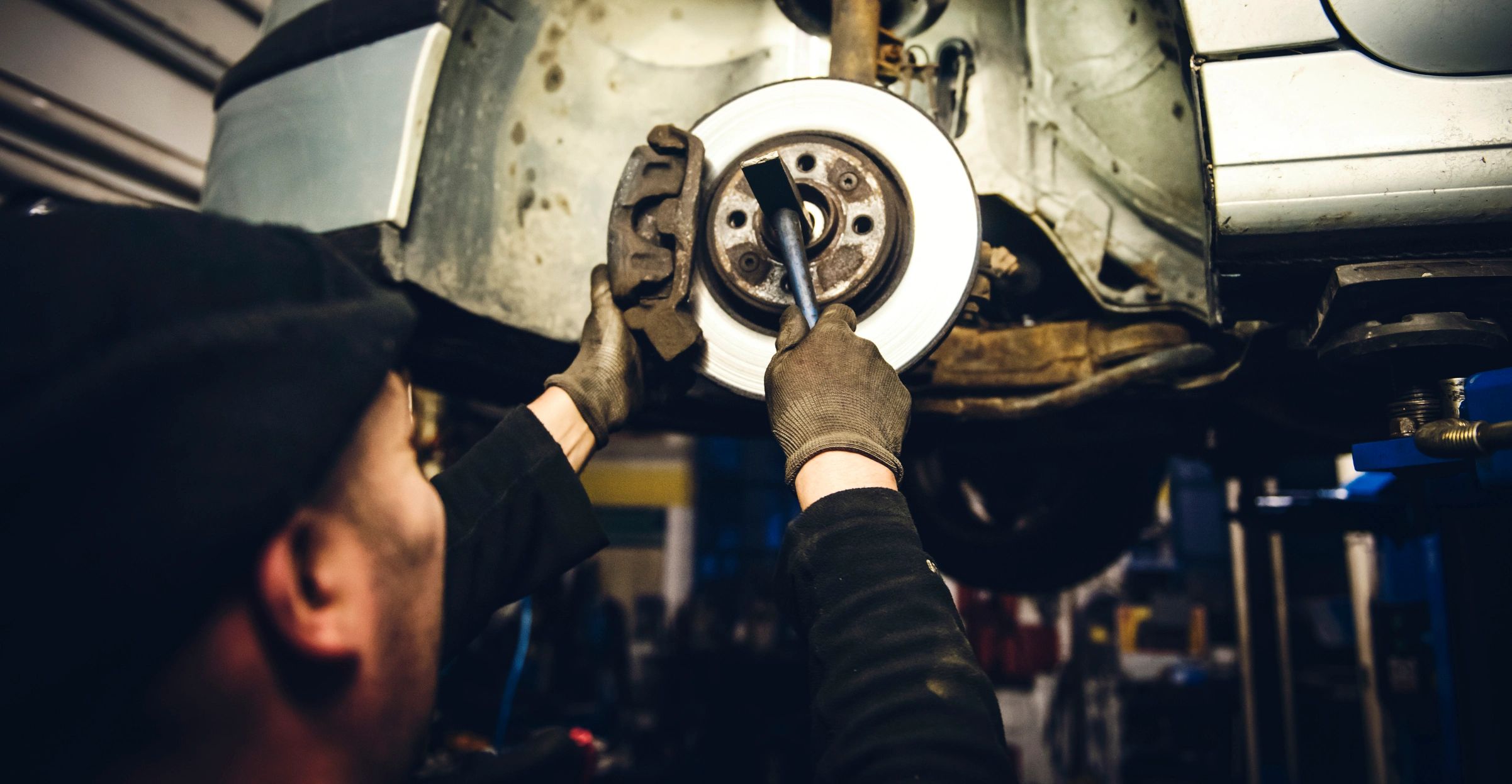 Auto mechanic working on a vehicle